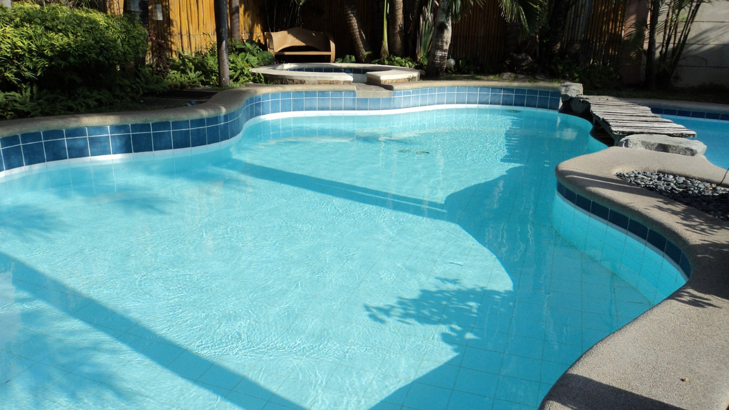 A large swimming pool with steps leading up to it